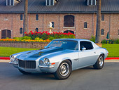CAM 04 RK0159 01
1972 Chevrolet Camaro RS Blue With Black Stripes 3/4 Front View On Pavement By Brick Building And Garden