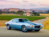 CAM 04 RK0163 01
1972 Chevrolet Camaro RS Blue With Black Stripes 3/4 Front View On Pavement By Vineyards And House