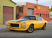 CAM 04 RK0253 01
1971 Chevrolet Camaro High Velocity Yellow With Charcoal Pearl Stripes 3/4 Front View On Pavement By Brick Building