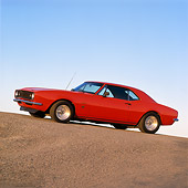 CAM 04 RK0039 07
1967 Chevrolet Camaro Red Slanted 3/4 Front View On Pavement Hill Blue Sky