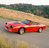 CAM 06 RK0008 06
1988 Chevrolet Camaro IROC-Z Convertible Red 3/4 Front View On Pavement By Field Trees