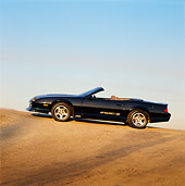 CAM 06 RK0019 06
1989 Black Iroc-Z Convertible Slanted Side View On Pavement Hill At Dusk