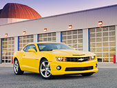 CAM 07 RK0121 01
2010 Chevrolet Camaro RS/SS Yellow 3/4 Front View On Pavement By Building