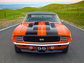 CAM 07 RK0134 01
1969 Chevrolet Camaro RS/SS Hugger Orange With Black Stripes Front View On Road By Grassy Hills At Dusk