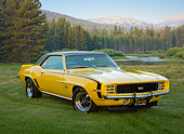 CAM 07 RK0135 01
1969 Chevrolet Camaro RS/SS Daytona Yellow 3/4 Front View On Grass By Mountains