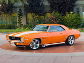 CAM 07 RK0091 01
1969 Chevrolet Camaro RS Orange White Stripe 3/4 Front View On Pavement By Trees