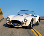 COB 01 RK0052 01
1966 Cobra 427 Convertible White 3/4 Front View On Road Hill Blue Sky