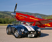 COB 01 RK0089 06
1967 Cobra 427 SC Blue White Stripe 3/4 Front View YAK 9U Airplane On Pavement Blue Sky