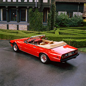 FRR 04 RK0139 04
1982 Ferrari 400I Red Convertible 3/4 Rear View On Wet Pavement By Bushes