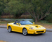 FRR 04 RK0249 02
2001 Ferrari Barchetta Yellow 3/4 Front View On Pavement By Water And Trees