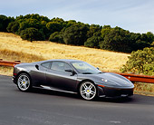 FRR 04 RK0383 04
2005 Ferrari F430 Grigio Silverstone 3/4 Side View On Pavement Hill By Dry Grass Hills And Trees