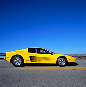 FRR 07 RK0054 02
1988 Yellow Ferrari Testarossa Profile View On Road With Driver Blue Sky