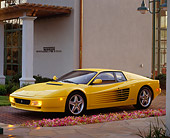 FRR 07 RK0075 02
1994 Ferrari Testarossa Yellow 3/4 Front View By Building And Flowers
