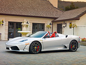 FRR 08 RK0129 01
2009 Ferrari F430 16M Scuderia Spider Silver 3/4 Front View On Pavement By House