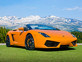 LAM 01 BK0014 01
2010 Lamborghini Gallardo Spyder Orange 3/4 Front View On Grass By Snowy Mountain Range