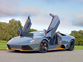 LAM 01 RK0755 01
2010 Lamborghini Murcielago LP650 Roadster Gray And Orange 3/4 Front View On Pavement By Golf Course