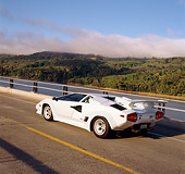 LAM 01 RK0186 02
Lamborghini Countach White 3/4 Rear View On Bridge By Water Hills Blue Sky Clouds