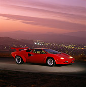 LAM 01 RK0405 05
Lamborghini Countach Red 3/4 Front View On Pavement City Lights At Dusk