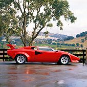 LAM 01 RK0407 02
Lamborghini Countach Red Side View On Wet Pavement By Tree Hills Background