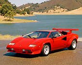 LAM 01 RK0424 02
Lamborghini Countach Red 3/4 Front View On Pavement By Lake Hills Trees Blue Sky
