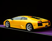 LAM 01 RK0458 02
2002 Lamborghini Murcielago Yellow 3/4 Rear View On Purple Floor Studio
