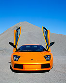 LAM 01 RK0481 11
2002 Lamborghini Murcielago Orange Head  On Gravel Blue Sky