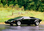 LAM 01 RK0516 04
Lamborghini Countach Black 3/4 Front View On Wet Pavement By Trees