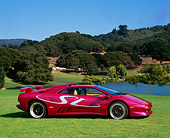 LAM 02 RK0114 02
1998 Lamborghini Diablo SV Custom Purple 3/4 Front View On Grass By Lake And Trees