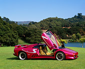 LAM 02 RK0115 02
1998 Lamborghini Diablo SV Custom Purple 3/4 Front View Doors Open On Grass By Lake