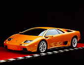 LAM 02 RK0142 01
2001 Lamborghini Diablo 6L Orange 3/4 Front View On Checkered Line Red Floor Studio