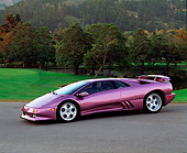 LAM 04 RK0004 11
1994 Lamborghini Diablo 30th Anniversary Edition Purple Front 3/4 View On Pavement By Grass And Trees