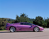 LAM 04 RK0016 04
1994 Lamborghini Diablo Purple 30th Anniversary Profile On Pavement By Trees Blue Sky