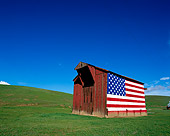LAN 03 RK0028 11
Red Barn With American Flag On Side On Green Grass Blue Sky