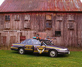 LAW 01 RK0009 03
1994 Ford Crown Victoria Ohio State Highway Patrol Car And Officers Drawing Guns By Barn