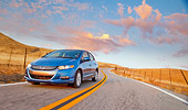 AUT 29 BK0011 02
2010 Honda Insight Blue 3/4 Front View Driving On Road