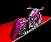 MOT 01 RK0478 02
2003 Riff Raff Custom Fuschia Orange Flames 3/4 Rear View On Orange Floor Gray Line Studio