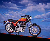 MOT 01 RK0332 01
1973 Triumph Hurricane Orange 3/4 Side View On Orange Line Cloudy Blue Sky Background