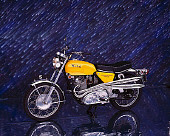 MOT 01 RK0335 02
1970 Norton S Type 750 Commando Yellow 3/4 Front View On Mylar Floor Meteor Shower Background