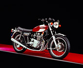 MOT 01 RK0553 02
1975 Triumph Trident Maroon And White 3/4 Side View On Red Floor Studio
