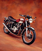 MOT 01 RK0556 02
1975 Triumph Trident Maroon And White Slanted 3/4 Side View On Brown Mottled Background
