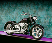 MOT 01 RK0602 04
2000 Harley Davidson, Fat Boy, Black With Flames 3/4 Side View On Purple Floor Green Background Studio