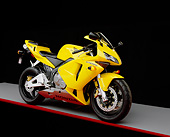 MOT 02 RK0109 02
2003 Honda CBR 600RR Yellow Side 3/4 View On Gray Floor Red Line Studio