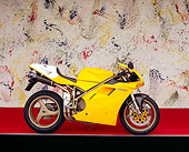 MOT 02 RK0153 07
1998 Ducati 748 Yellow Profile View On Red Floor Splattered Paint Studio