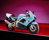 MOT 02 RK0250 08
1999 Honda CBR 900RR Light Blue 3/4 Side View On Red Floor Purple Shading Studio