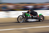 MOT 05 RK0006 01
1947 Harley Davidson Dual Knucklehead Green And Red Side 3/4 View In Motion On Race Track By Start Light