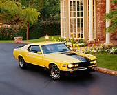 MST 01 RK0236 04
1970 Ford Mustang Mach 1 Yellow Black Stripes 3/4 Front View On Pavement By House