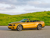 MST 01 RK1236 01
2010 Ford Mustang Gold 3/4 Front View On Pavement By Grassy Hills