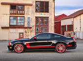 MST 01 RK1644 01
2012 Ford Mustang Boss 302 Laguna Seca Edition Black And Red Profile View On Pavement By Old Buildings