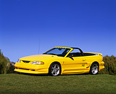 MST 01 RK0001 10
1994 Ford Mustang P-51  Convertible Yellow 3/4 Side View On Grass Hill
Blue Sky