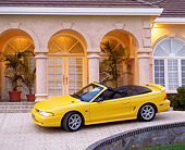 MST 01 RK0005 14
1994 Ford Mustang GT Convertible Yellow 3/4 Side View On Driveway By House